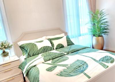 Bright and cozy bedroom with plant-themed bedding