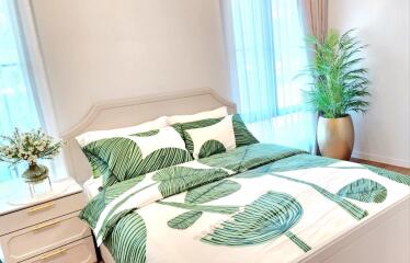 Bright and cozy bedroom with plant-themed bedding