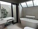 Modern bathroom with bathtub and large windows