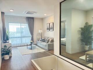 Modern and bright living room with a view into a bedroom