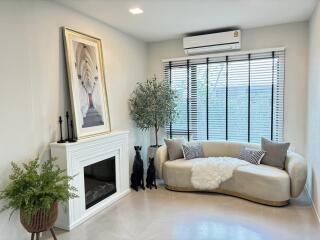 Modern living room with sofa, fireplace and air conditioner