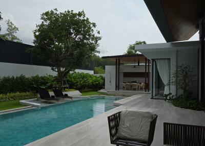 Outdoor area with swimming pool, sun loungers, and patio seating