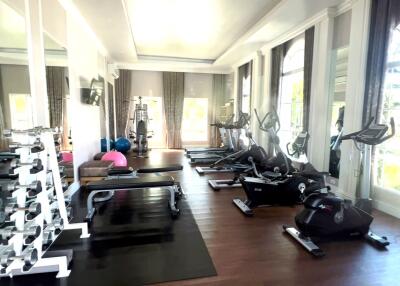 Spacious home gym with natural lighting and modern equipment