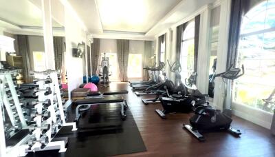 Spacious home gym with natural lighting and modern equipment