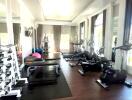 Spacious home gym with natural lighting and modern equipment