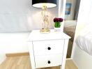 bedside table with lamp and flowers