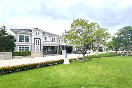 Exterior view of residential buildings with a well-manicured lawn