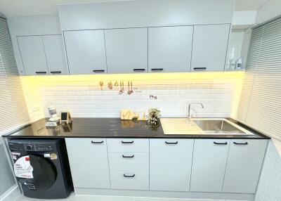 Modern kitchen with grey cabinets and black countertop