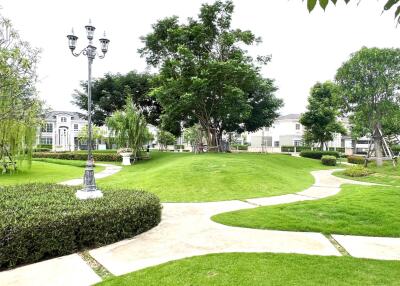 Well-maintained garden with lush greenery and walking paths