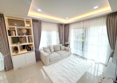 Modern living room with white sofa and large windows