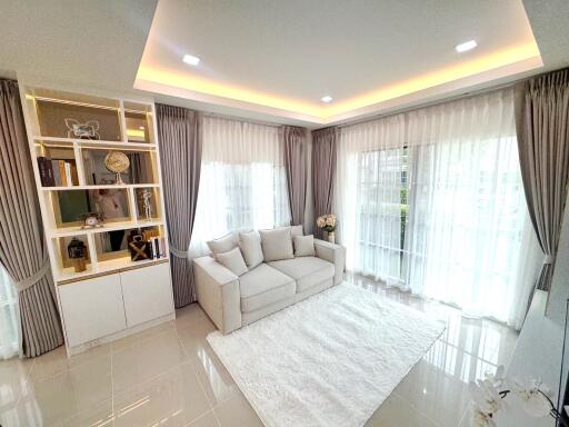 Modern living room with white sofa and large windows