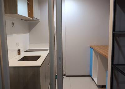 Modern kitchen area with white countertops and integrated sink