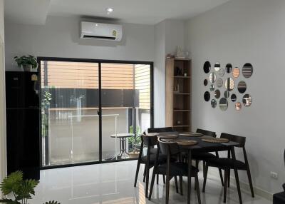 Modern dining area with large window and contemporary decor