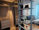 Modern walk-in closet with glass shelves and built-in lighting