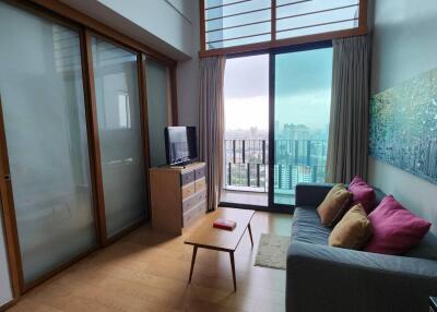 Modern living room with large windows and balcony view