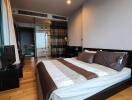 Modern bedroom with double bed, TV, and ensuite bathroom