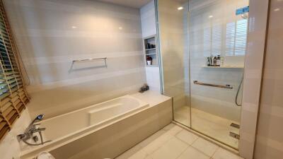 Modern bathroom with bathtub and shower area