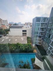 View of modern residential buildings with swimming pool and greenery