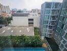 View of modern residential buildings with swimming pool and greenery