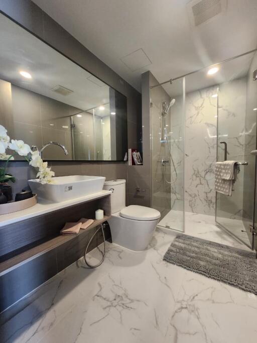 Modern bathroom with glass shower and marble floor