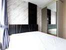 Modern bedroom with large window and mirrored wardrobe