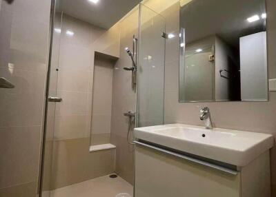 Modern bathroom with glass-enclosed shower and sleek vanity