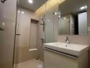 Modern bathroom with glass-enclosed shower and sleek vanity