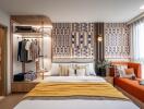 Modern bedroom with decorative wall, cozy furniture, and open wardrobe