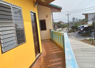 Outside view of balcony with yellow wall