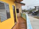 Outside view of balcony with yellow wall