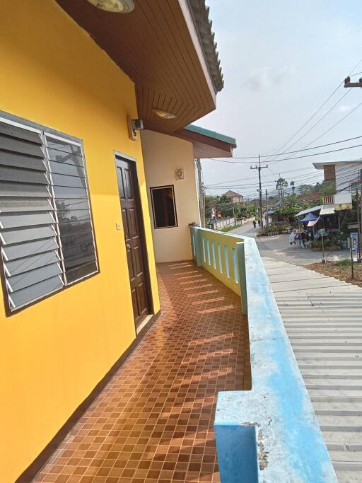 Outside view of balcony with yellow wall