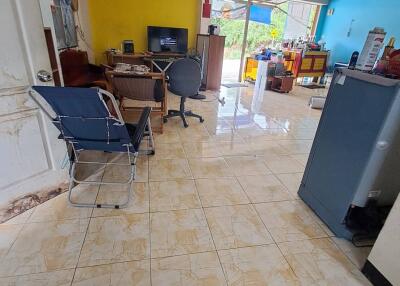 Spacious living room with tile flooring and bright walls