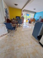 Spacious living room with tile flooring and bright walls