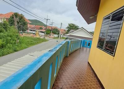 Balcony view with mosaic tile floor and blue railing