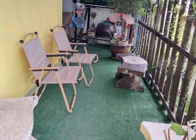 Cozy balcony with seating area and potted plants