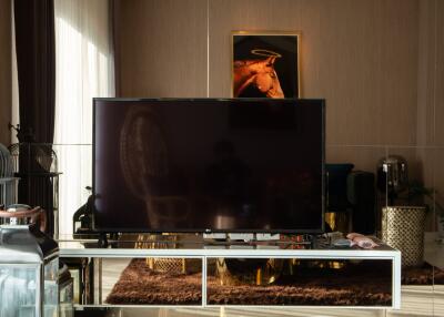 Modern living room with a TV, wall art, and elegant decor