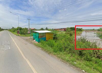 Roadside view with a small structure and greenery