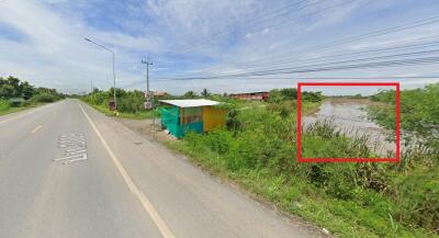 Roadside view with a small structure and greenery