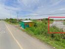 Street view with roadside structure and greenery