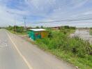 Outdoor roadside view with a small makeshift shelter