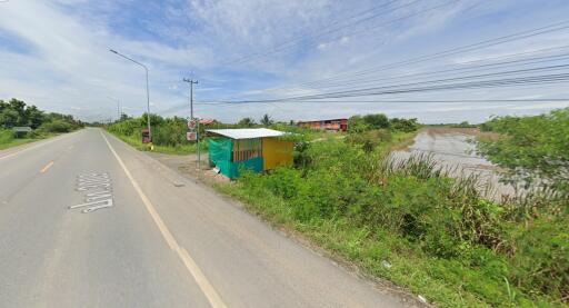 Outdoor roadside view with a small makeshift shelter