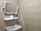 Bathroom with tiled walls, mirror, sink, and shelf