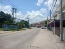 Street view showing residential buildings and power lines