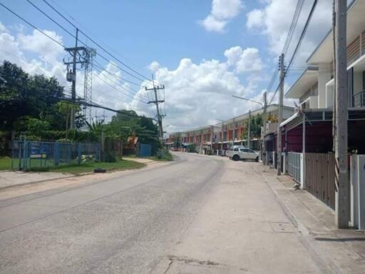 Street view showing residential buildings and power lines