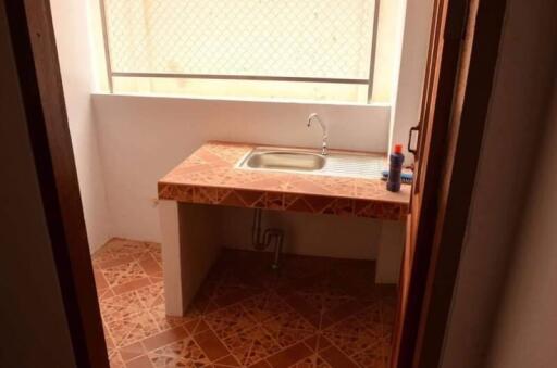 Small kitchen area with tiled countertop