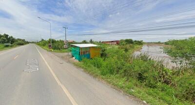 View of a roadside with a small shelter and greenery