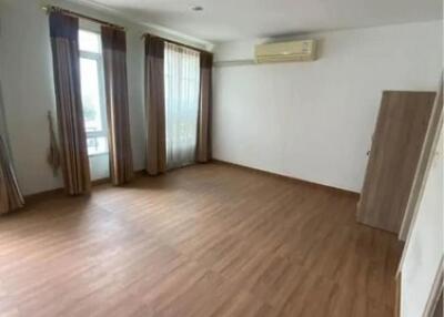 Spacious, well-lit main living area with wooden flooring and large windows