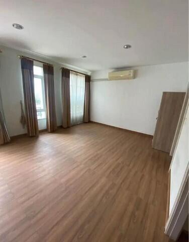 Spacious, well-lit main living area with wooden flooring and large windows