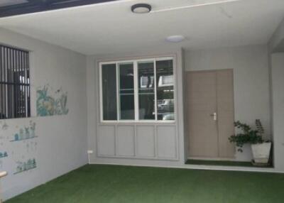 Covered garage with artificial grass and decorations