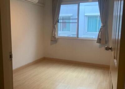 Empty bedroom with wooden floor and window